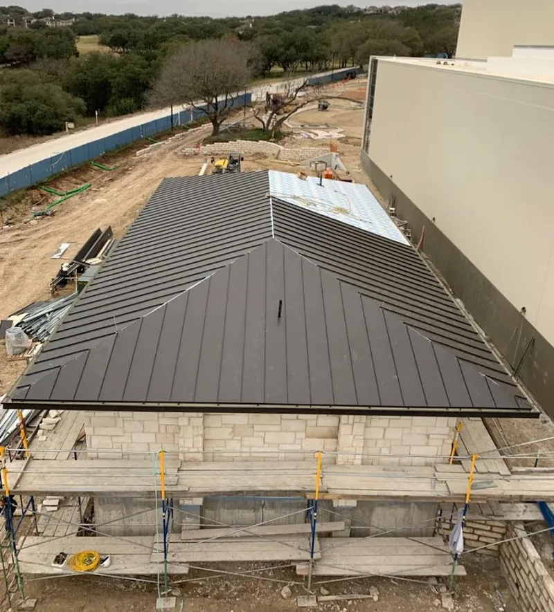 Metal roof new construction with scaffolding in Littleton